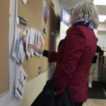 Minister Hajdu looking at job postings at Northwest Employment Works